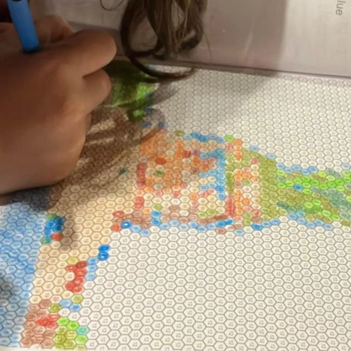 A mystery mosaic page being colored by number